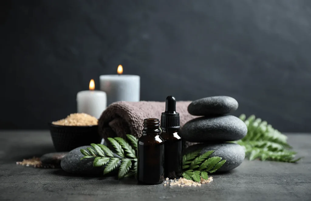 spa composition with aroma oil on grey table